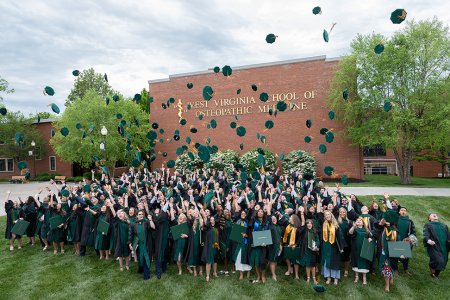 Graduates toss caps in the air