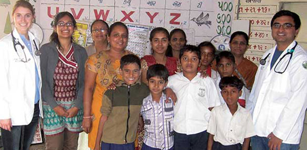 WVSOM student with group of patients in India