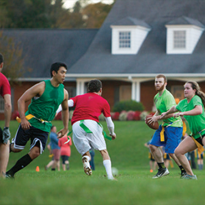 Students playing flag football on parade field