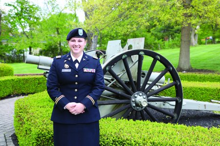 Anne Reis, D.O., stands in front of a cannon on the WVSOM campus