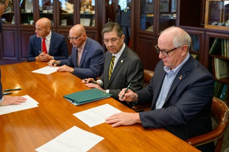 Dr. James W. Nemitz, Ph.D., and others attend a signing ceremony with the Greenbrier Military School Alumni Association