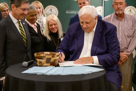Gov. Jim Justice and others gather for bill signing