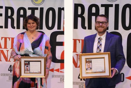 Katie Williams, Ph.D., and Matthew Davis, D.O., stand with their awards