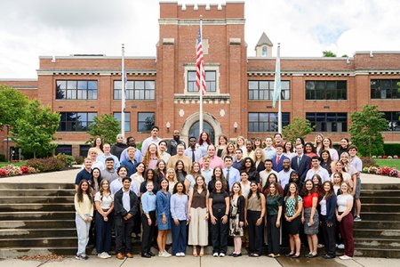 Members of the MSBS Class of 2027 standing in front of the main building