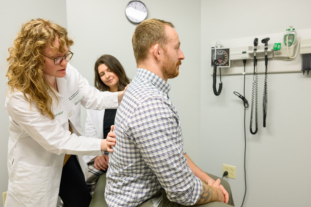 Phyaician and student doing an exam