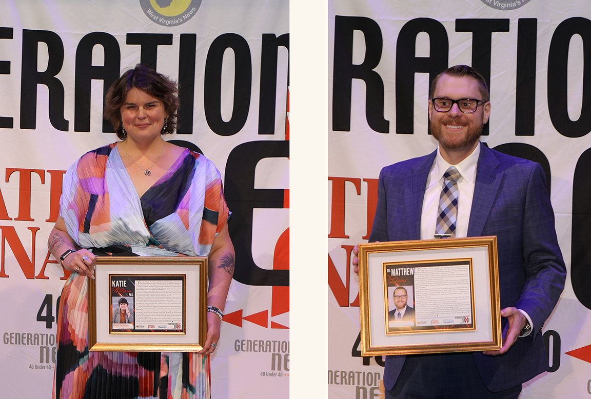 Katie Williams, Ph.D., and Matthew Davis, D.O., stand with their awards