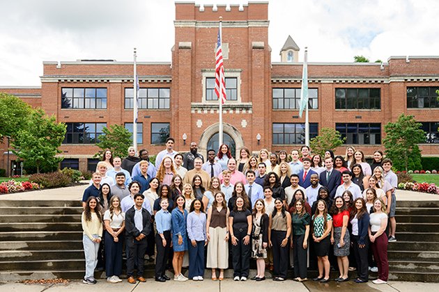 Members of the MSBS Class of 2027 standing in front of the main building