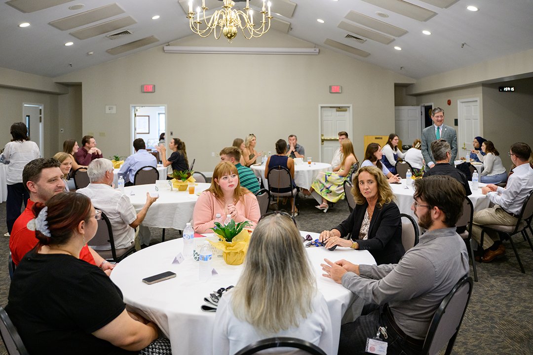 Students gathered at tables for a reception