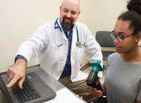 Doctor pointing at computer