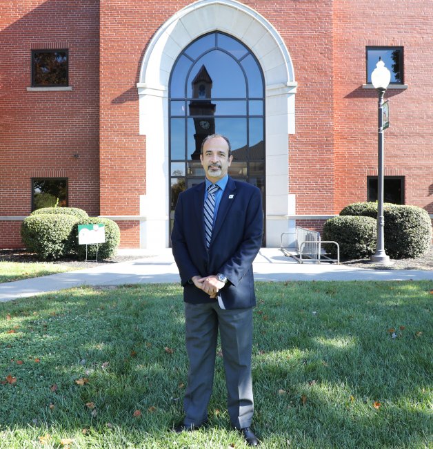 Dr. Talal El-Hefnawy stands in front of the WVSOM Fredric W. Smith Science Building.